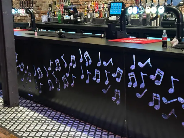 Bespoke music note metalwork detailing to a bar counter front