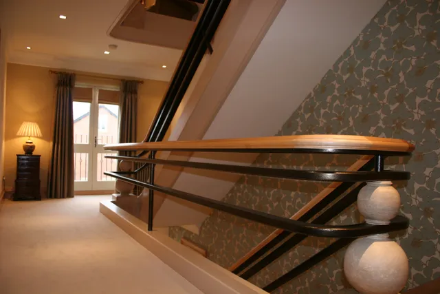 Bespoke curved handrail and staircase detail in a private residence
