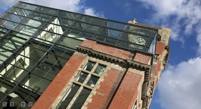 Structural glazing and steel atrium addition to a brick building