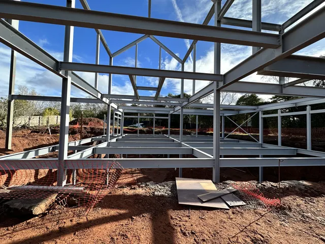 Structural steel portal frame and glazing supports during erection