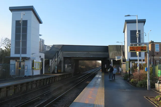 Platform-level view of the Meols station footbridge and lift towers