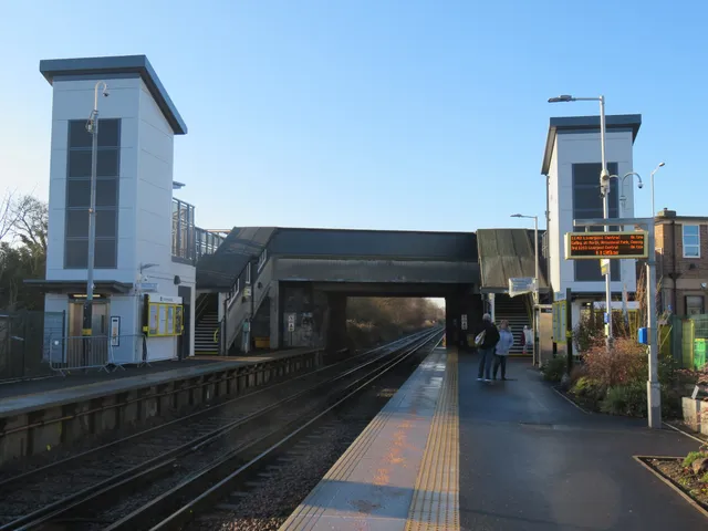 Platform-level view of the Meols station footbridge and lift towers