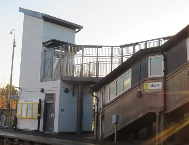 Meols station buildings and new steel footbridge with platform signage