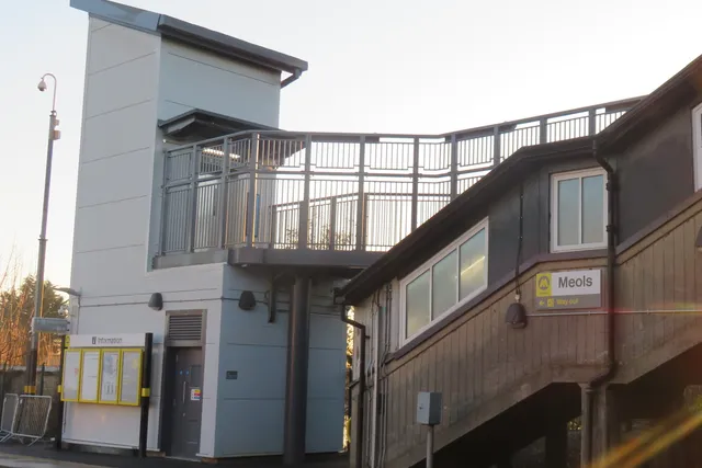 Meols station buildings and new steel footbridge with platform signage
