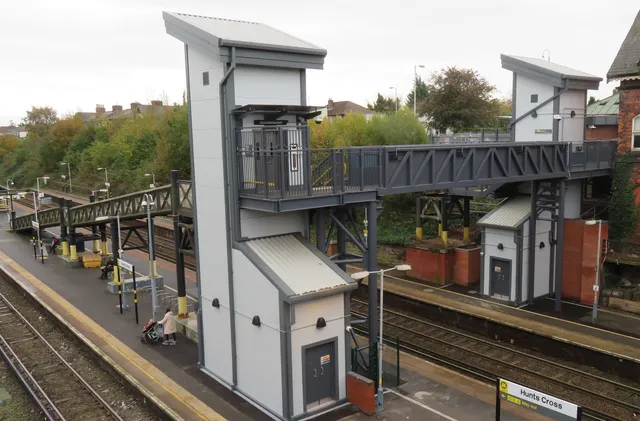 Meols station footbridge spanning the Wirral line between two new lift towers