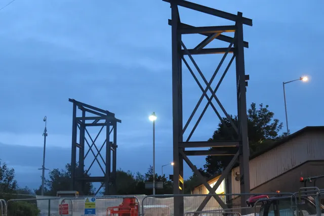 Steel lift tower frames erected at Meols station at dusk during the Merseyrail accessibility works