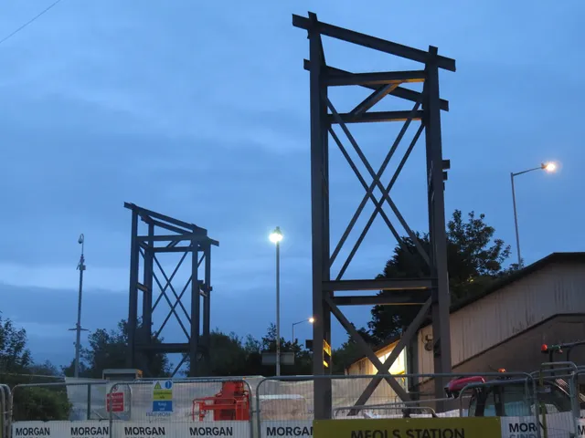 Steel lift tower frames erected at Meols station at dusk during the Merseyrail accessibility works
