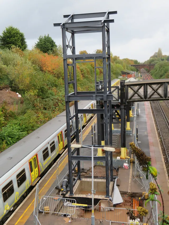 Steel railway footbridge span installed over the running line at a Merseyrail station