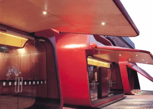 Curved red architectural steel canopy and cladding to a public building entrance