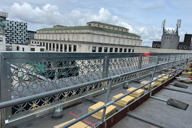 Decorative perforated balustrade panels to a rooftop walkway in Liverpool city centre