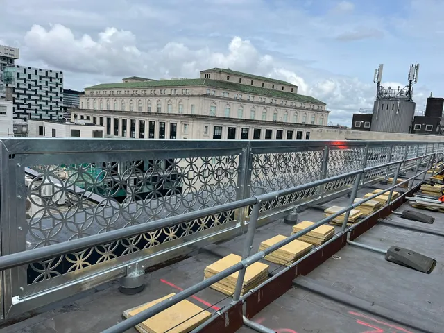 Decorative perforated balustrade panels to a rooftop walkway in Liverpool city centre