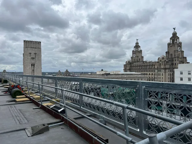 Rooftop balustrade run with the Royal Liver Building and Liverpool waterfront behind