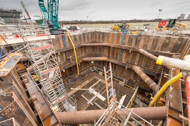 Aerial view of a deep shaft excavation with steel propping frames