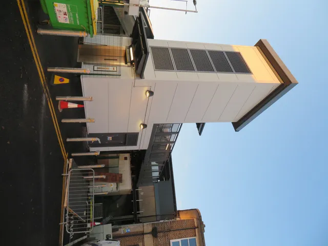 Approach view of a station lift tower and footbridge landing