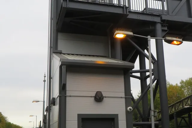 Accessible lift tower with adjoining steel staircase at a Merseyrail station
