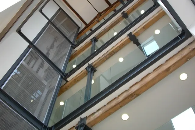 Steel and structural glass balustrades to an atrium stairwell, viewed from below
