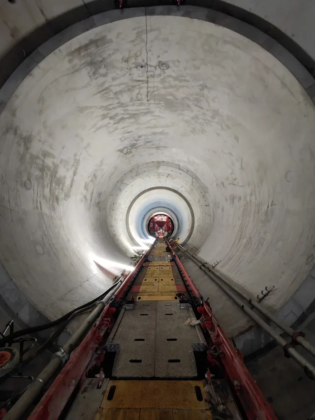 Steel gantry and track systems installed inside a concrete-lined tunnel drive